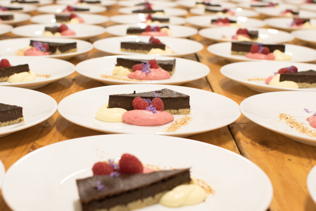 Chocolate Almond Tarts on white plates on a table.