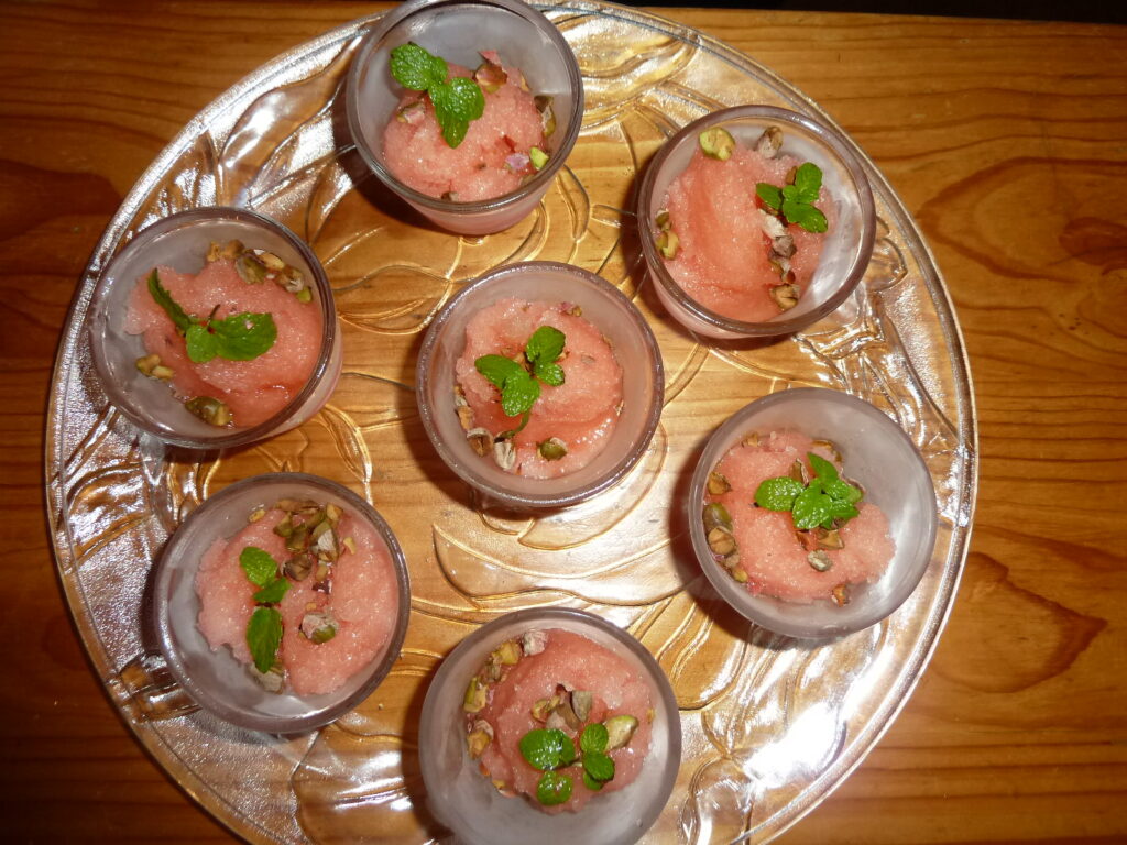Seven bowls of Sorbet Rosewater and Mint on a glass tray.
